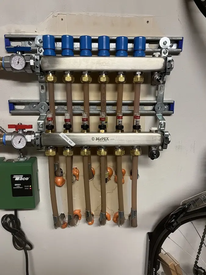 Plumber performing Water Heater Repair at a residential property in Manchester